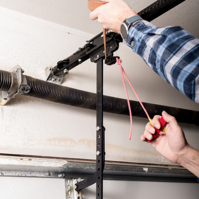 handyman lubricating garage door lever